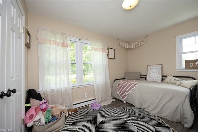 4345 Mcintyre Rd, Gibsonville, NC 27249 - bedroom with a baseboard heating unit and wood finished floors