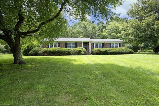 4345 Mcintyre Rd, Gibsonville, NC 27249 - ranch-style house featuring a front yard and brick siding