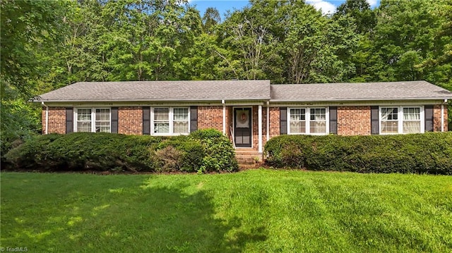 4345 Mcintyre Rd, Gibsonville, NC 27249 - view of front of home with a front yard and brick siding