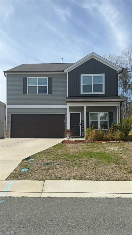 view of front of home featuring board and batten siding, driveway, and an attached garage