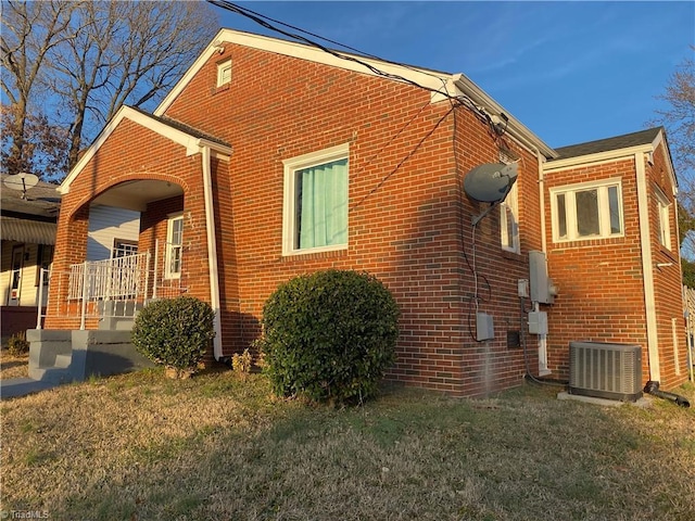 view of home's exterior featuring central AC and a lawn