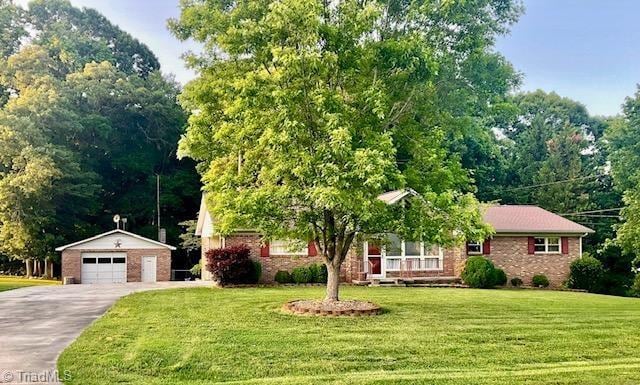 327 Lanier Dr, Lexington, NC 27295 - ranch-style house with a detached garage, an outbuilding, a front lawn, and brick siding