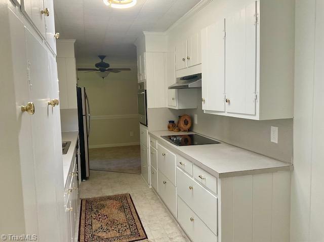 327 Lanier Dr, Lexington, NC 27295 - kitchen with black appliances, under cabinet range hood, light countertops, white cabinetry, and ceiling fan