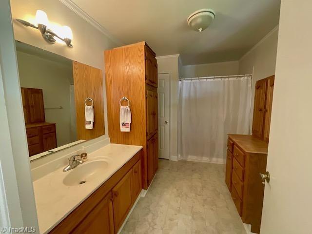 327 Lanier Dr, Lexington, NC 27295 - full bathroom featuring vanity, ornamental molding, and a shower with curtain
