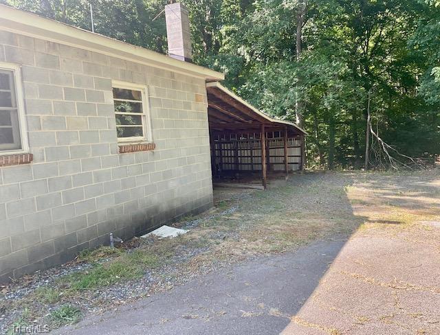 327 Lanier Dr, Lexington, NC 27295 - view of home's exterior with a chimney and concrete block siding