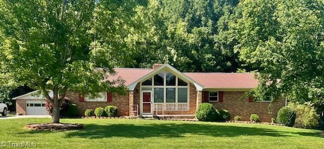 327 Lanier Dr, Lexington, NC 27295 - view of front of home featuring a front yard, a garage, brick siding, and concrete driveway