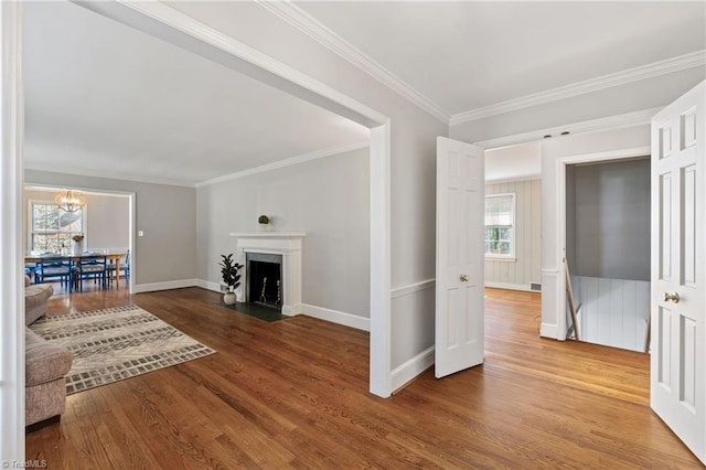 living room with hardwood / wood-style flooring, crown molding, and a notable chandelier