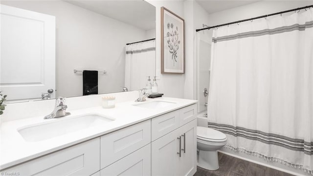 full bathroom with vanity, hardwood / wood-style flooring, toilet, and shower / bath combo with shower curtain