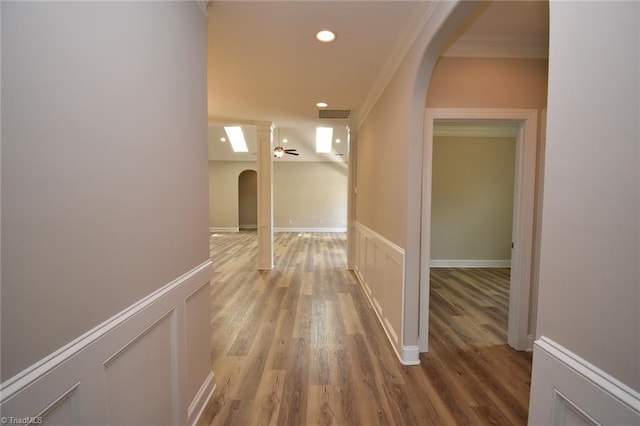 corridor featuring crown molding and wood-type flooring