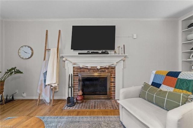 living room featuring hardwood / wood-style flooring, a fireplace, and ornamental molding