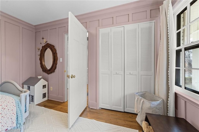 bedroom featuring light wood-type flooring and a closet