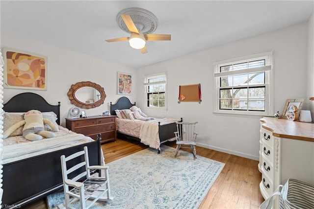 bedroom with light hardwood / wood-style flooring and ceiling fan