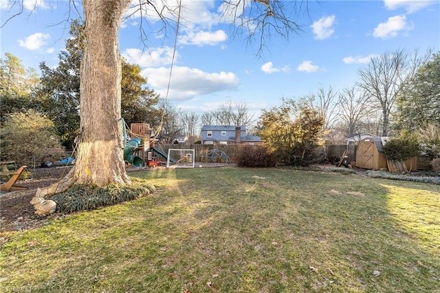 view of yard featuring a storage shed and a playground