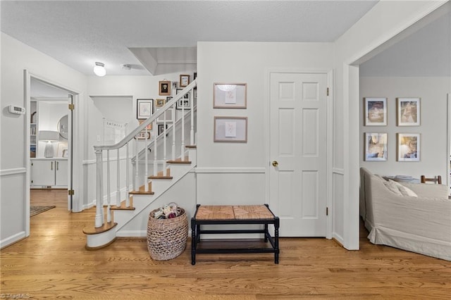 foyer featuring hardwood / wood-style floors and a textured ceiling