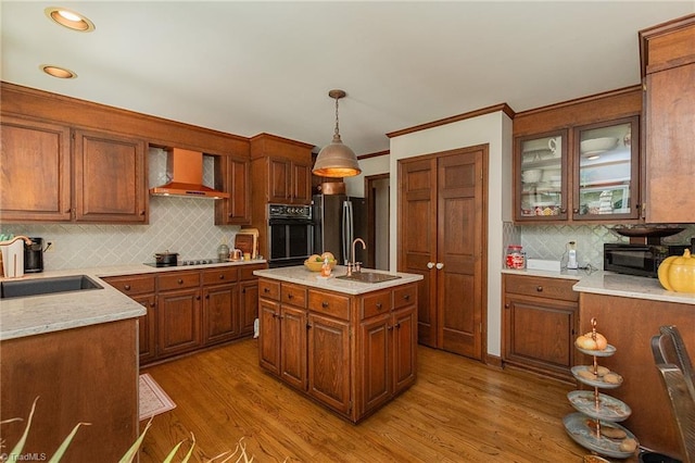 250 Oakmont Ter, Lexington, NC 27295 - kitchen featuring wall chimney exhaust hood, black appliances, decorative backsplash, brown cabinets, and decorative light fixtures