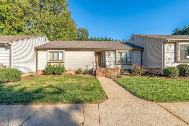 single story home featuring a front lawn