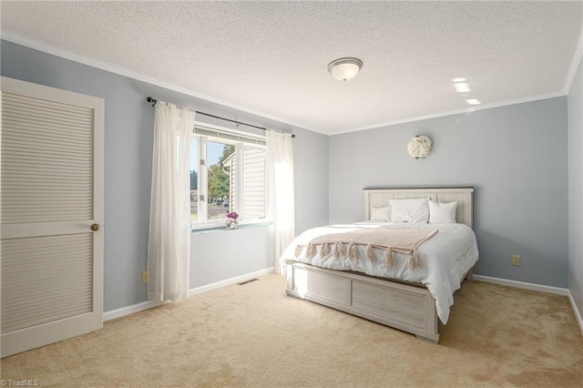 bedroom featuring crown molding, a textured ceiling, and light colored carpet