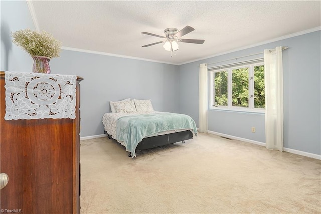 carpeted bedroom with crown molding, a textured ceiling, and ceiling fan