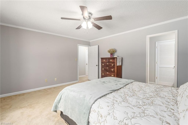 carpeted bedroom with ceiling fan, crown molding, and a textured ceiling