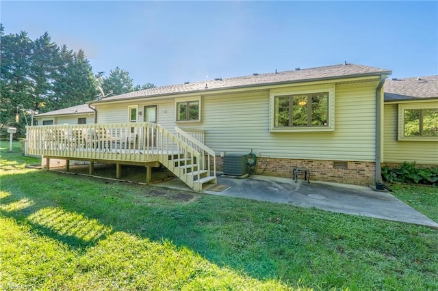 back of house featuring central AC, a yard, a deck, and a patio