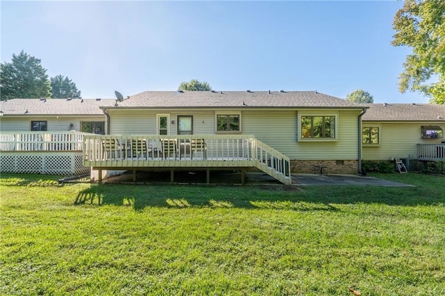 back of house featuring a deck and a yard