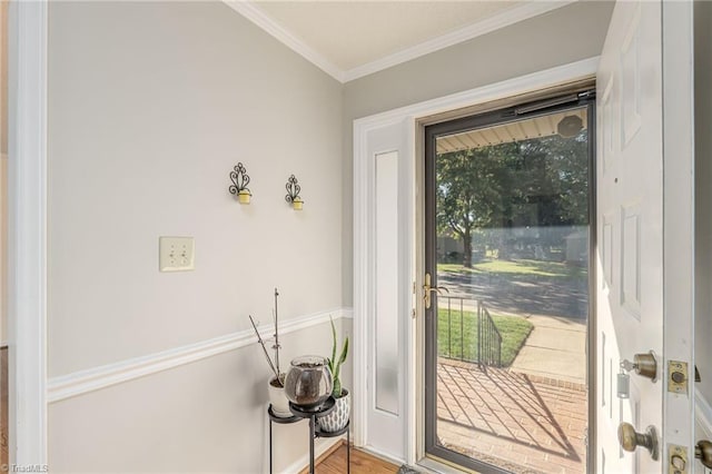 entryway featuring crown molding, a wealth of natural light, and hardwood / wood-style floors