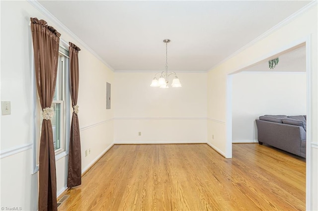 unfurnished dining area with light hardwood / wood-style floors, ornamental molding, and a chandelier