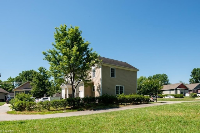 view of property exterior with a yard