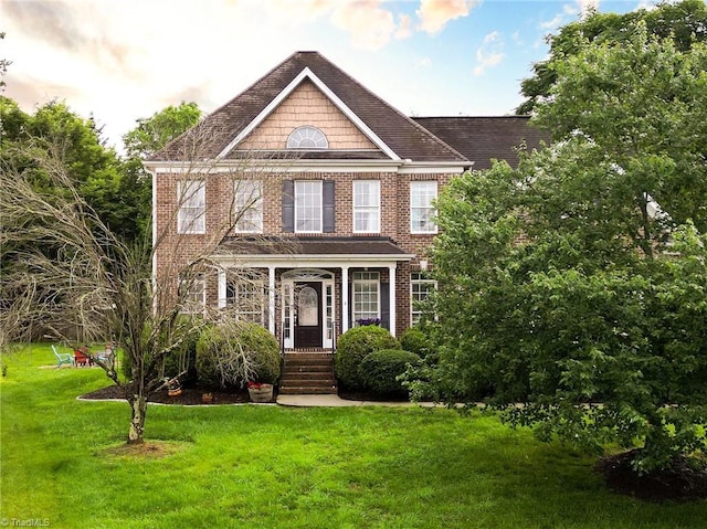 15 Orchard Grass Ct, Greensboro, NC 27410 - colonial house featuring a front lawn and brick siding