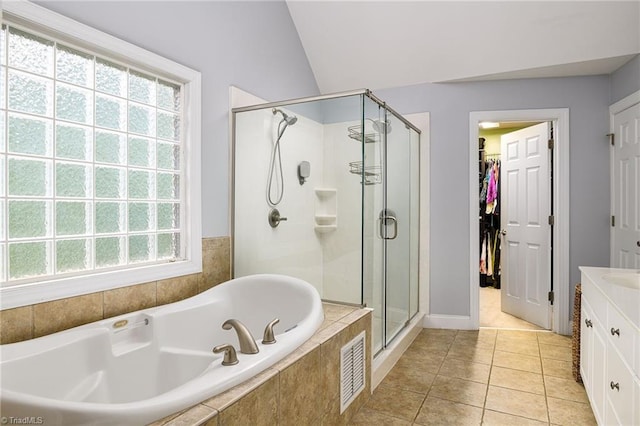 15 Orchard Grass Ct, Greensboro, NC 27410 - bathroom featuring a shower stall, a bath, vanity, tile patterned floors, and lofted ceiling