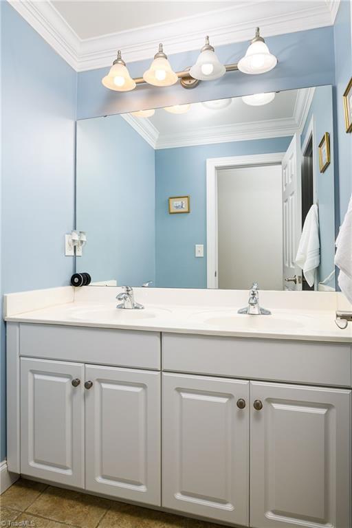 15 Orchard Grass Ct, Greensboro, NC 27410 - bathroom with double vanity and ornamental molding