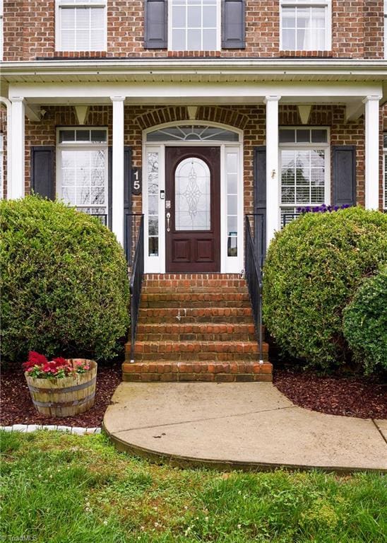 15 Orchard Grass Ct, Greensboro, NC 27410 - entrance to property featuring brick siding and covered porch