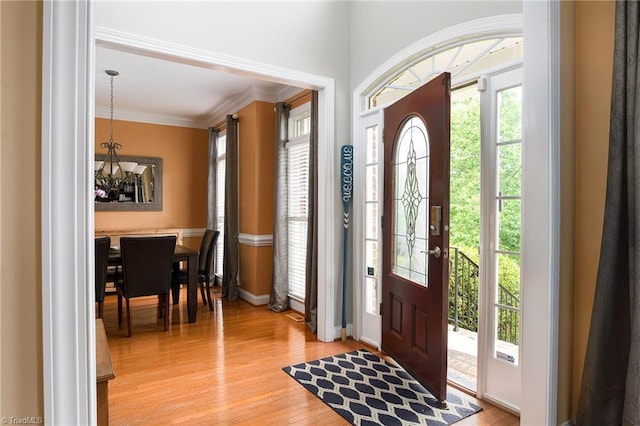 15 Orchard Grass Ct, Greensboro, NC 27410 - foyer with a chandelier, light wood finished floors, baseboards, and ornamental molding