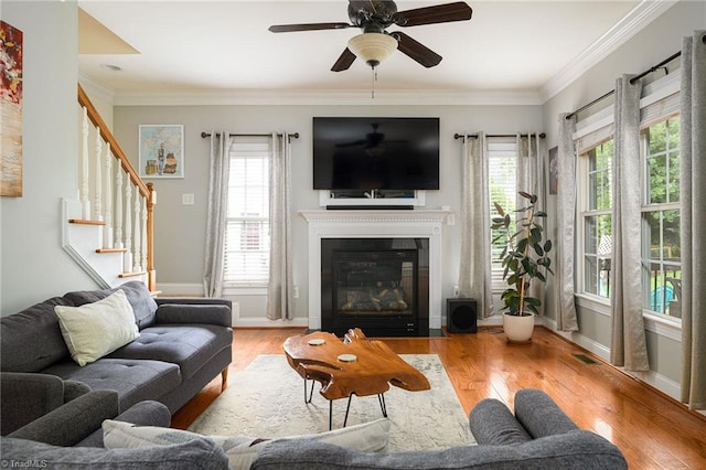 15 Orchard Grass Ct, Greensboro, NC 27410 - living area featuring wood finished floors, stairway, ceiling fan, a glass covered fireplace, and baseboards