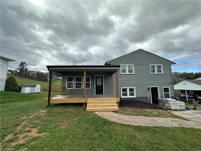 tri-level home with a porch, a front yard, and a deck