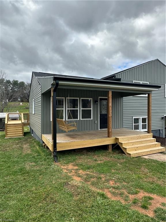 rear view of property with a yard