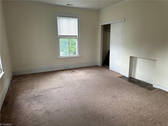 spare room featuring dark colored carpet