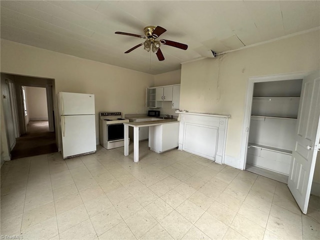 kitchen featuring ceiling fan, white appliances, and white cabinetry