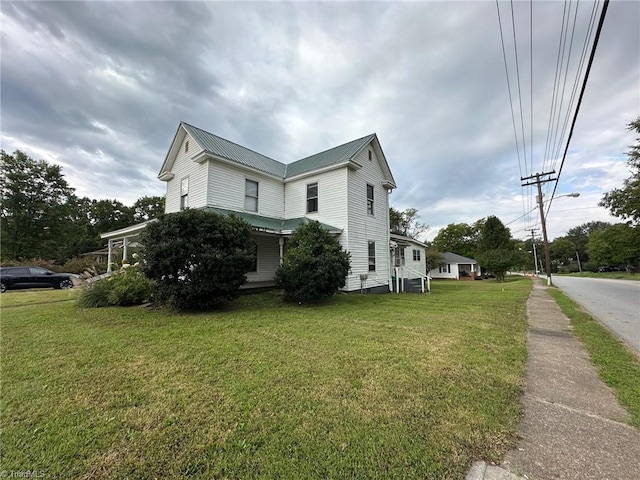 view of property exterior with a lawn