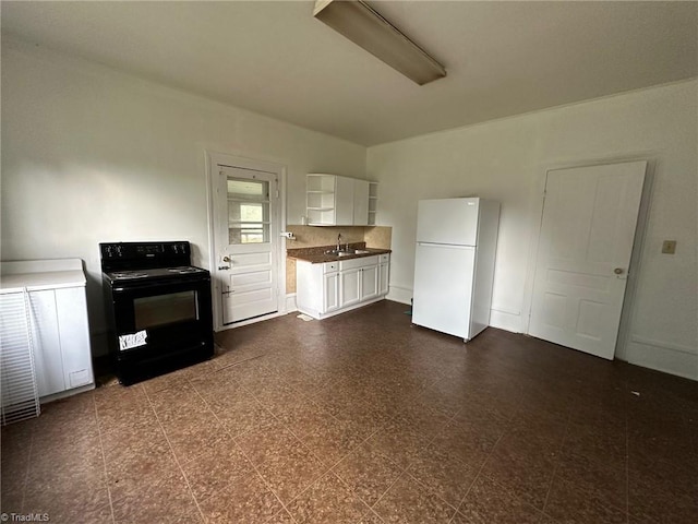 kitchen featuring black range with electric cooktop, white fridge, sink, and white cabinets