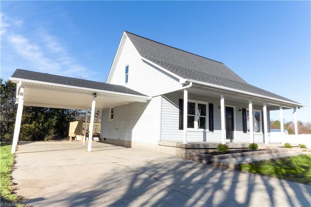 view of front of house featuring roof with shingles, a porch, concrete driveway, and a carport