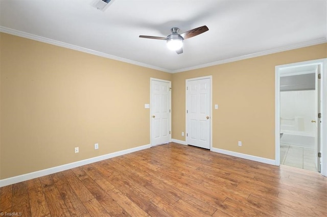 unfurnished bedroom with crown molding, ceiling fan, ensuite bathroom, and light hardwood / wood-style floors