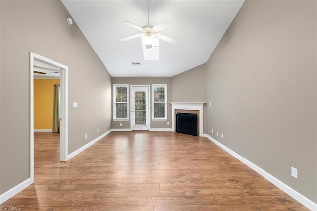 unfurnished living room featuring light wood finished floors, visible vents, baseboards, and a ceiling fan