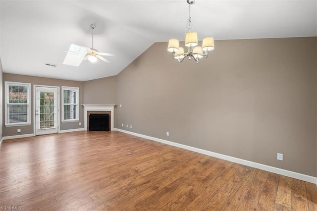 unfurnished living room featuring hardwood / wood-style floors, ceiling fan with notable chandelier, and lofted ceiling