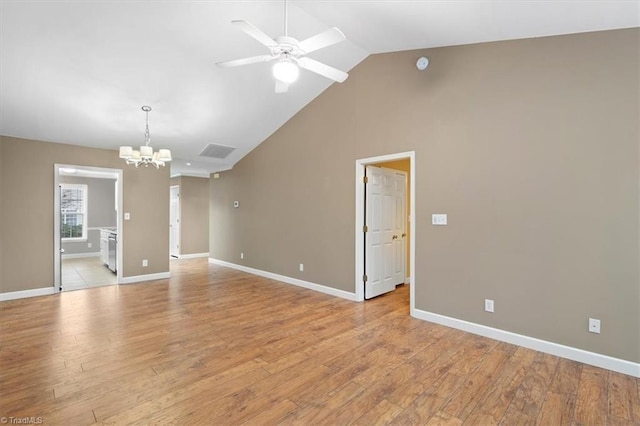 empty room with light wood finished floors, ceiling fan with notable chandelier, and baseboards