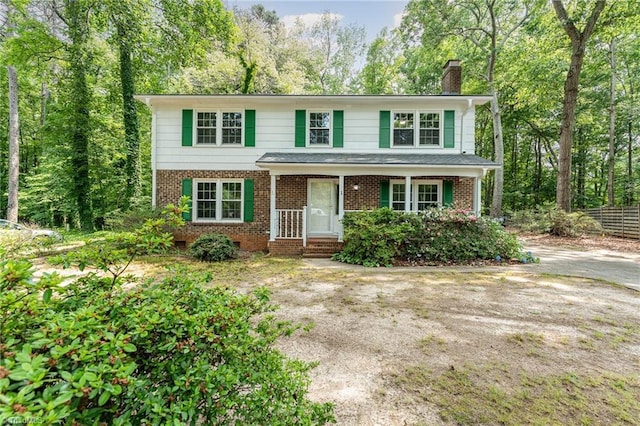 1 Red Fern Ct, Greensboro, NC 27455 - view of front of house featuring a chimney, brick siding, and a porch