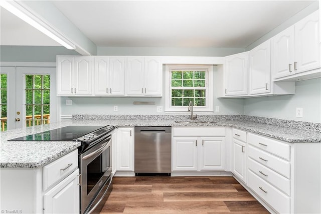 1 Red Fern Ct, Greensboro, NC 27455 - kitchen with stainless steel appliances, a sink, light stone countertops, a peninsula, and white cabinets