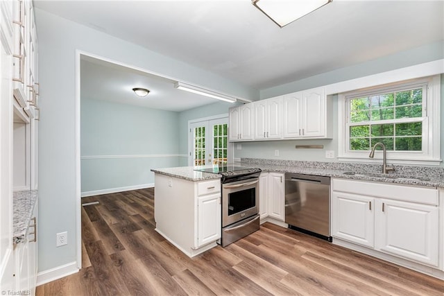 1 Red Fern Ct, Greensboro, NC 27455 - kitchen with appliances with stainless steel finishes, a sink, white cabinetry, a peninsula, and light stone counters