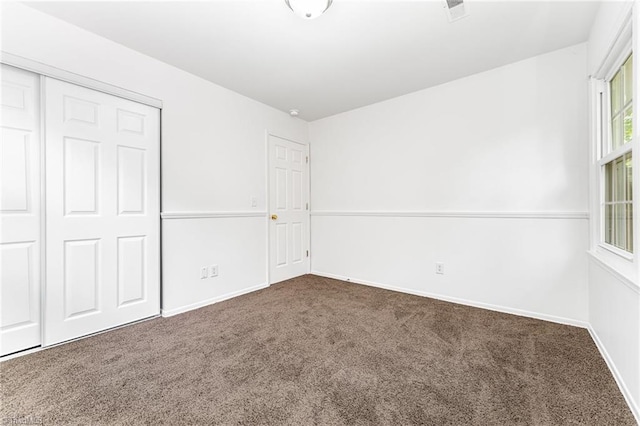 1 Red Fern Ct, Greensboro, NC 27455 - unfurnished bedroom featuring carpet, a closet, and baseboards
