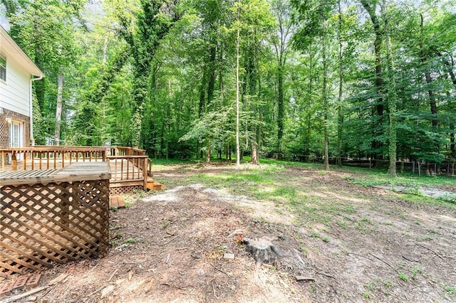 1 Red Fern Ct, Greensboro, NC 27455 - view of yard featuring a wooden deck and a view of trees